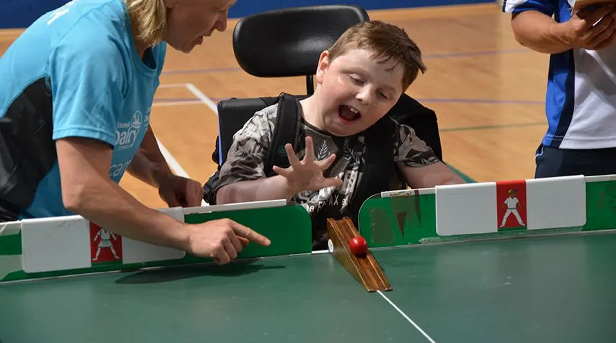 A Child Playing Table Cricket